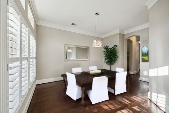 8227 Caroline Ridge Dr, Humble, TX 77396 - dining room with arched walkways, crown molding, baseboards, dark wood-style floors, and a chandelier
