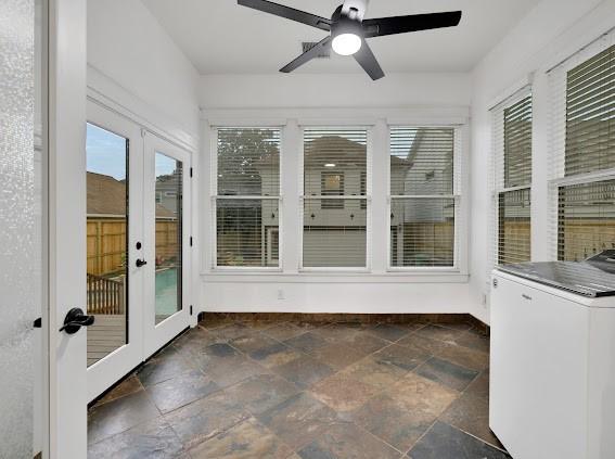 1408 W 23rd St, Houston, TX 77008 - unfurnished sunroom with washer / clothes dryer, french doors, baseboards, and stone tile flooring