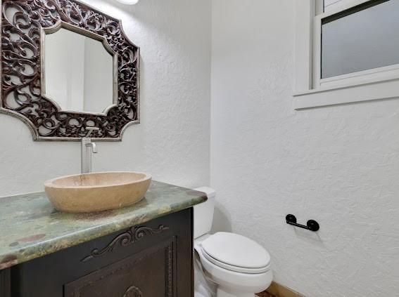 1408 W 23rd St, Houston, TX 77008 - bathroom with a textured wall, vanity, and toilet