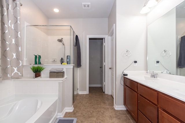 full bathroom with a stall shower, a garden tub, double vanity, baseboards, and tile patterned flooring