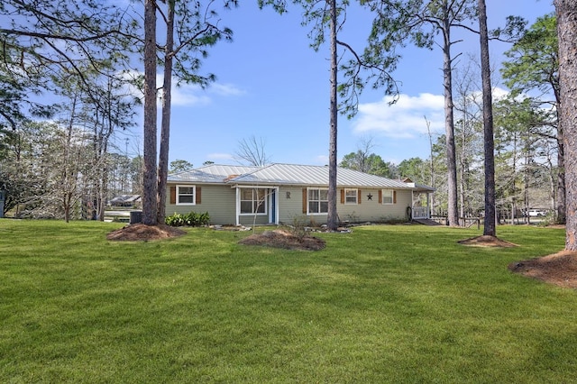 212 Woodcrest Dr, Brookeland, TX 75931 - rear view of property featuring a yard, metal roof, and a standing seam roof