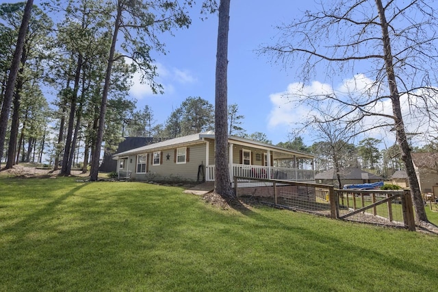 212 Woodcrest Dr, Brookeland, TX 75931 - rear view of house featuring a yard, fence, and covered porch