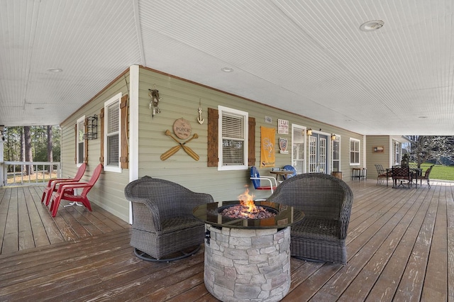 212 Woodcrest Dr, Brookeland, TX 75931 - deck featuring an outdoor fire pit and covered porch