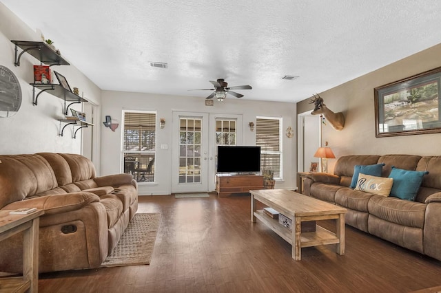 212 Woodcrest Dr, Brookeland, TX 75931 - living area with visible vents, dark wood-style flooring, a ceiling fan, a textured ceiling, and french doors