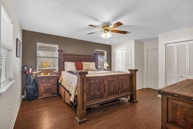 212 Woodcrest Dr, Brookeland, TX 75931 - bedroom with a textured ceiling, a ceiling fan, wood finished floors, multiple closets, and baseboards