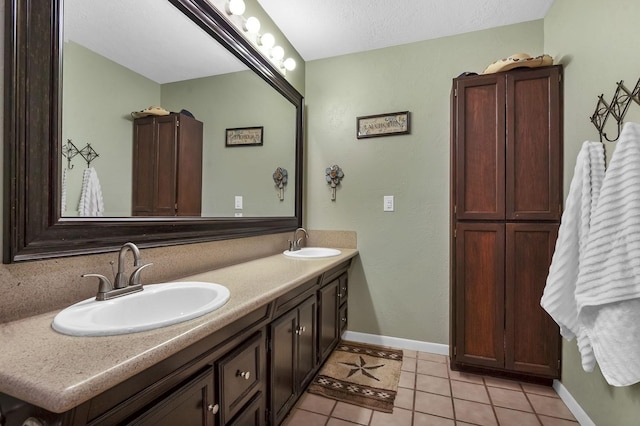 212 Woodcrest Dr, Brookeland, TX 75931 - bathroom with a sink, baseboards, double vanity, and tile patterned flooring