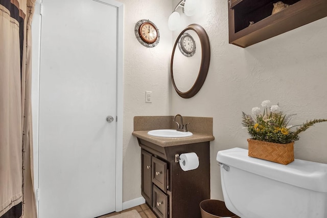 212 Woodcrest Dr, Brookeland, TX 75931 - bathroom with toilet, vanity, and a textured wall