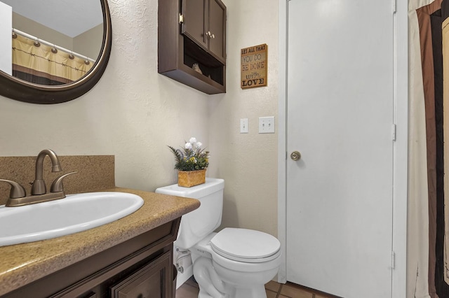 212 Woodcrest Dr, Brookeland, TX 75931 - bathroom featuring a textured wall, vanity, and toilet