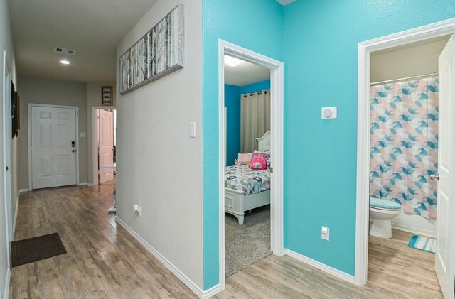 21003 Iris Holly St, Katy, TX 77449 - hallway featuring wood finished floors, baseboards, visible vents, and recessed lighting