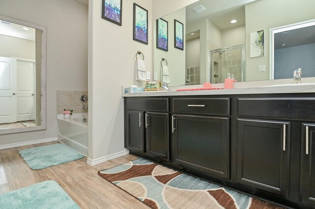 21003 Iris Holly St, Katy, TX 77449 - full bathroom featuring a shower stall, a bath, vanity, wood finished floors, and baseboards
