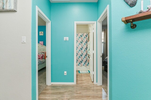 21003 Iris Holly St, Katy, TX 77449 - hallway featuring baseboards, wood finished floors, and a textured wall