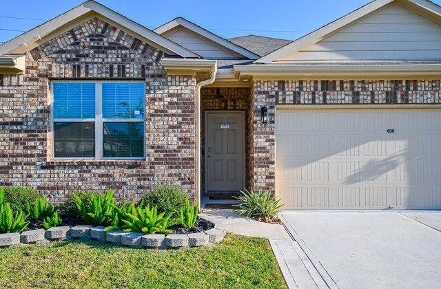 21003 Iris Holly St, Katy, TX 77449 - view of front of home with an attached garage, driveway, and brick siding