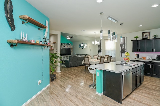 21003 Iris Holly St, Katy, TX 77449 - kitchen with open floor plan, an island with sink, a breakfast bar area, dishwasher, and a sink