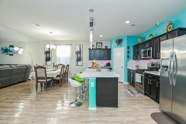 21003 Iris Holly St, Katy, TX 77449 - kitchen with open floor plan, appliances with stainless steel finishes, light countertops, and visible vents