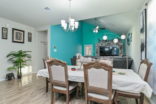21003 Iris Holly St, Katy, TX 77449 - dining space featuring light wood finished floors, baseboards, vaulted ceiling, and visible vents