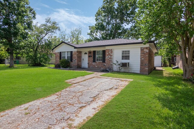 view of front of house with a front yard and brick siding