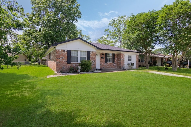 ranch-style home featuring a front yard and brick siding