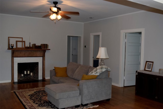 living room with dark wood-style flooring, ornamental molding, baseboards, and ceiling fan