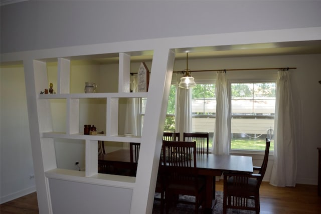 dining area featuring baseboards and wood finished floors