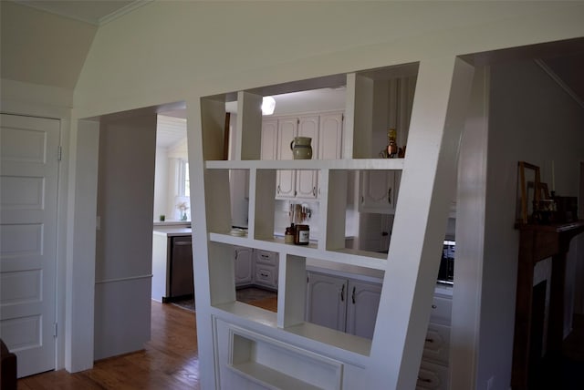 interior space featuring crown molding, wood finished floors, and dishwashing machine