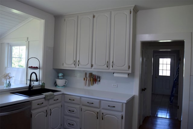 kitchen with dishwasher, a sink, white cabinetry, and a healthy amount of sunlight