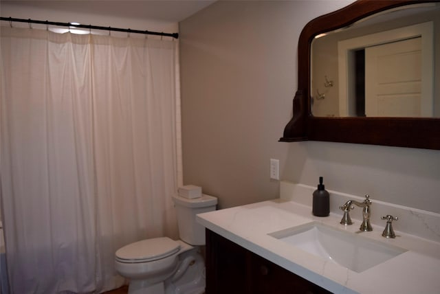 bathroom featuring toilet, a shower with curtain, and vanity