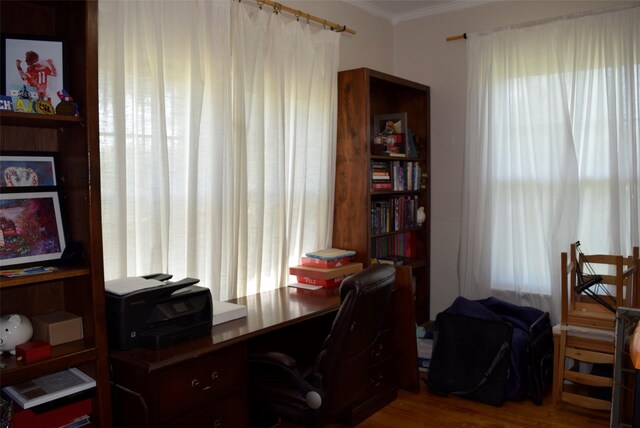 home office with wood finished floors and crown molding
