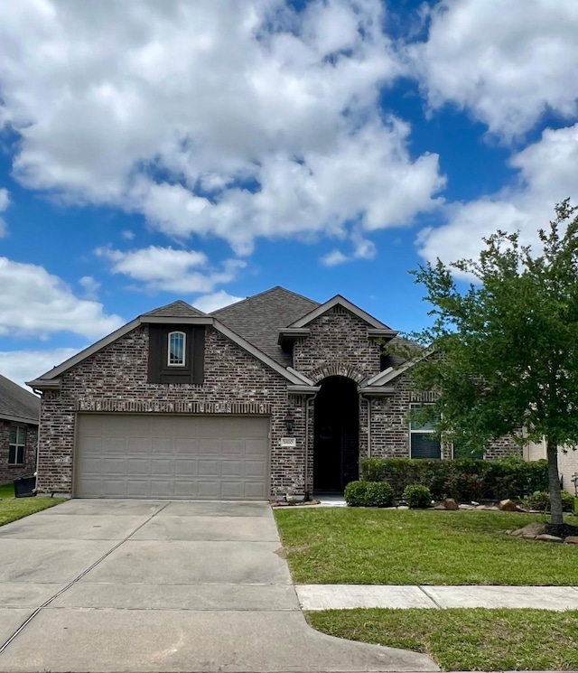 1610 Nacogdoches Valley Dr, League City, TX 77573 - view of front of house featuring driveway, stone siding, an attached garage, a front yard, and brick siding