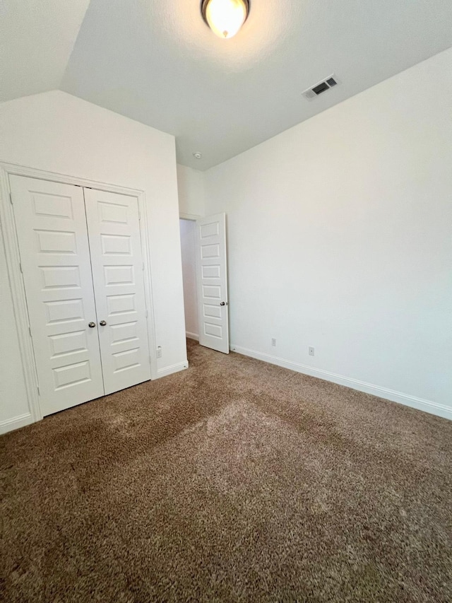1610 Nacogdoches Valley Dr, League City, TX 77573 - unfurnished bedroom featuring baseboards, a closet, vaulted ceiling, carpet flooring, and visible vents