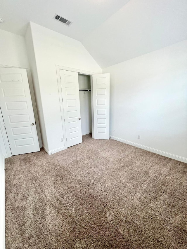 1610 Nacogdoches Valley Dr, League City, TX 77573 - unfurnished bedroom with a closet, baseboards, visible vents, carpet floors, and lofted ceiling