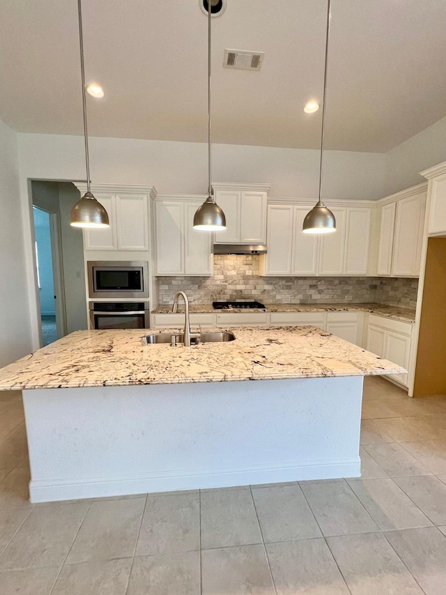 1610 Nacogdoches Valley Dr, League City, TX 77573 - kitchen featuring appliances with stainless steel finishes, white cabinetry, visible vents, decorative backsplash, and a sink