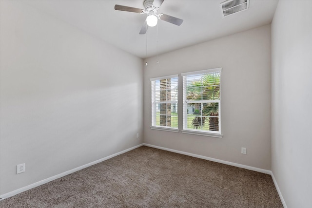 carpeted empty room featuring baseboards and ceiling fan
