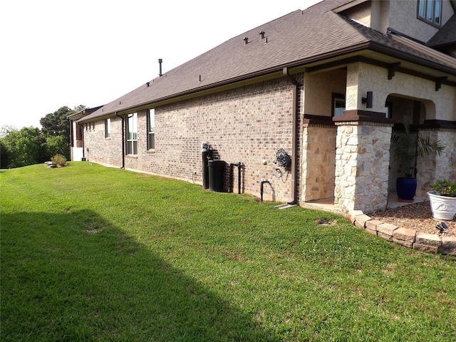 89 Grandview Blvd, Montgomery, TX 77356 - view of home's exterior featuring a yard, brick siding, and a shingled roof