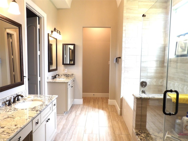 89 Grandview Blvd, Montgomery, TX 77356 - full bathroom featuring a stall shower, two vanities, baseboards, and a tub to relax in