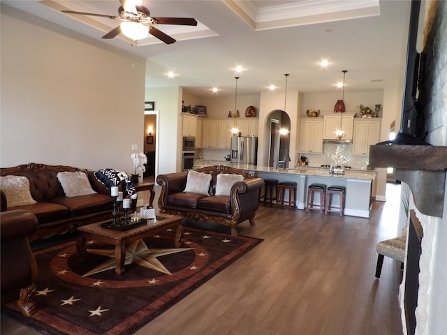 89 Grandview Blvd, Montgomery, TX 77356 - living area with dark wood finished floors, a ceiling fan, arched walkways, a tray ceiling, and recessed lighting