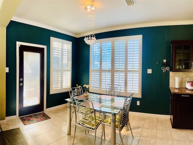 9307 Langley Springs Dr, Houston, TX 77095 - dining room with baseboards, a chandelier, crown molding, and light tile patterned flooring