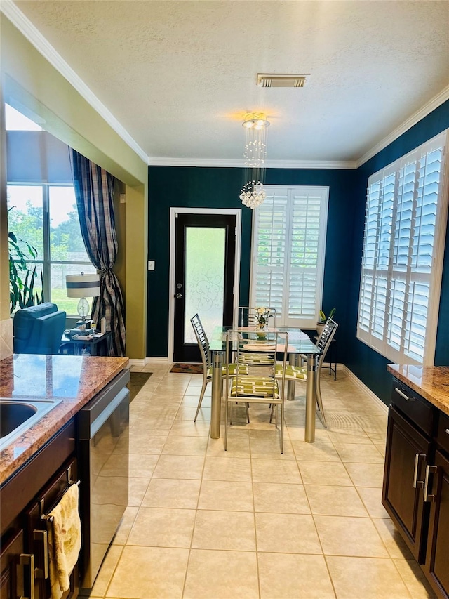 9307 Langley Springs Dr, Houston, TX 77095 - dining room featuring healthy amount of natural light, light tile patterned flooring, crown molding, a chandelier, and baseboards