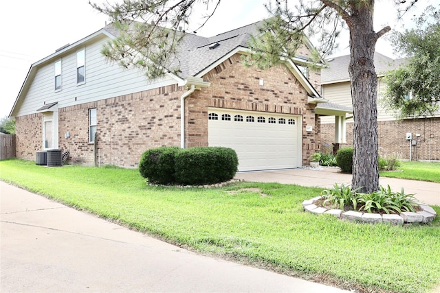 9307 Langley Springs Dr, Houston, TX 77095 - view of front of property with a garage, concrete driveway, brick siding, and a front lawn