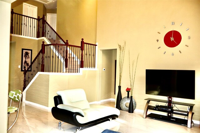 9307 Langley Springs Dr, Houston, TX 77095 - living room featuring a high ceiling, baseboards, marble finish floors, and stairway