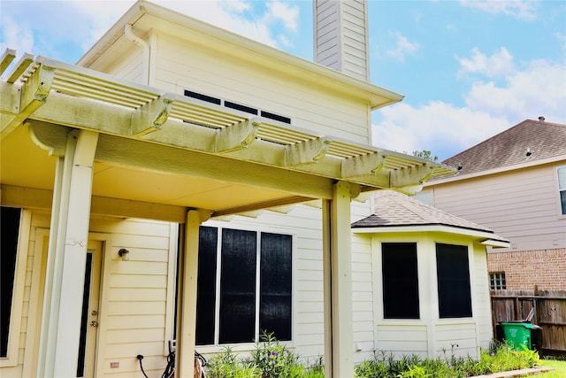 9307 Langley Springs Dr, Houston, TX 77095 - rear view of property featuring a pergola, a chimney, and a shingled roof
