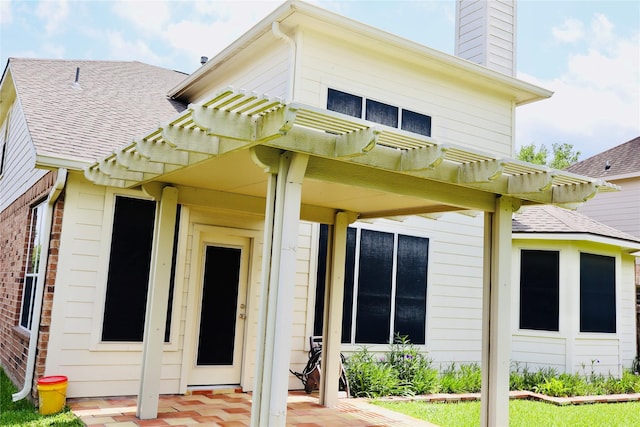 9307 Langley Springs Dr, Houston, TX 77095 - back of house with a pergola, a shingled roof, a chimney, and a patio area