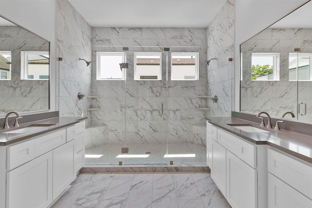 full bath featuring a wealth of natural light, marble finish floor, and a sink