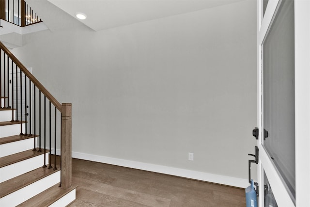 stairway with recessed lighting, baseboards, and wood finished floors