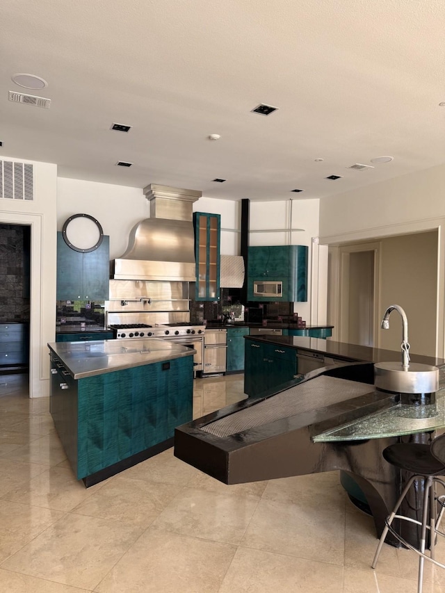 kitchen with dark countertops, custom exhaust hood, and a spacious island