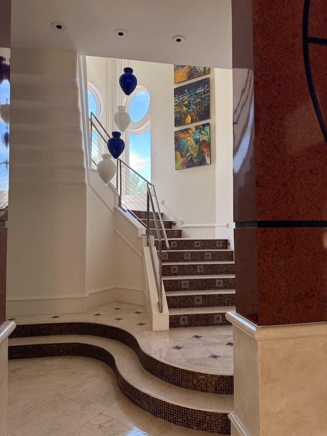 staircase with tile patterned floors and baseboards
