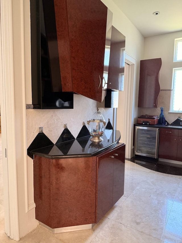 kitchen featuring wine cooler, dark countertops, modern cabinets, and light tile patterned flooring