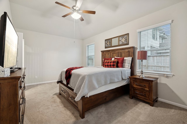 bedroom featuring light carpet, baseboards, a ceiling fan, and lofted ceiling