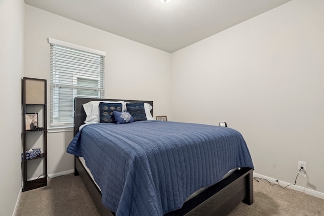 bedroom featuring carpet flooring and baseboards