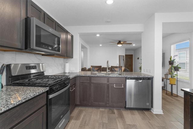 kitchen featuring light wood-style floors, appliances with stainless steel finishes, ceiling fan, and dark brown cabinets