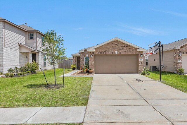 ranch-style home featuring central air condition unit, a front yard, brick siding, an attached garage, and concrete driveway